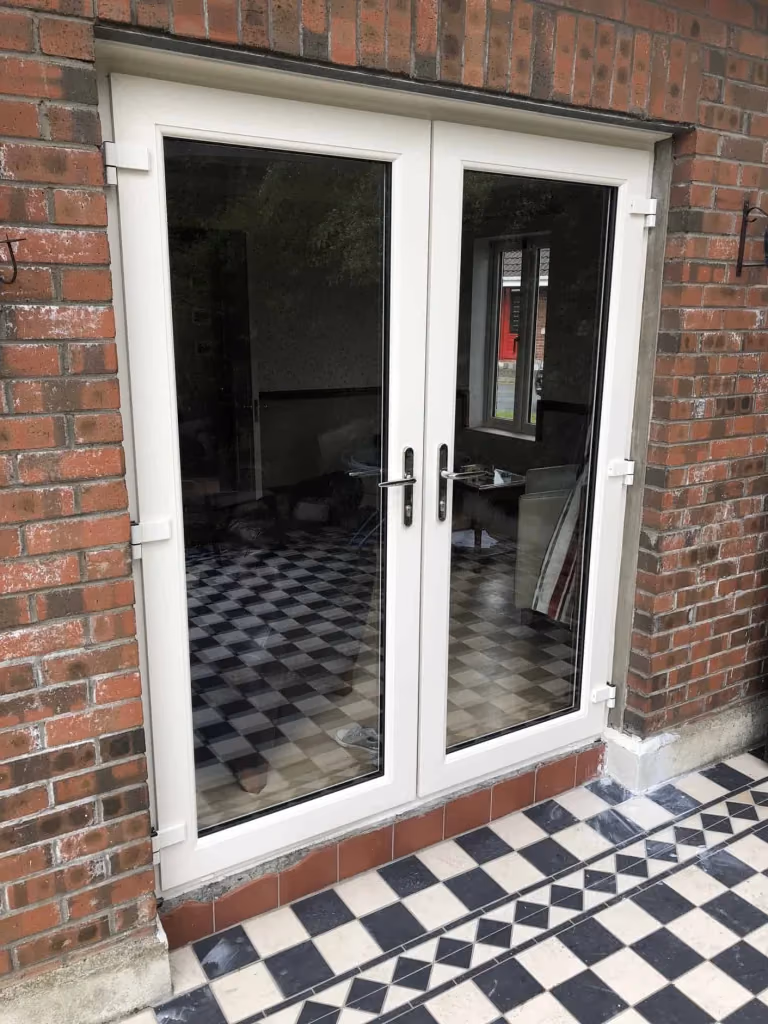 White uPVC French doors fitted in a Dublin brick home