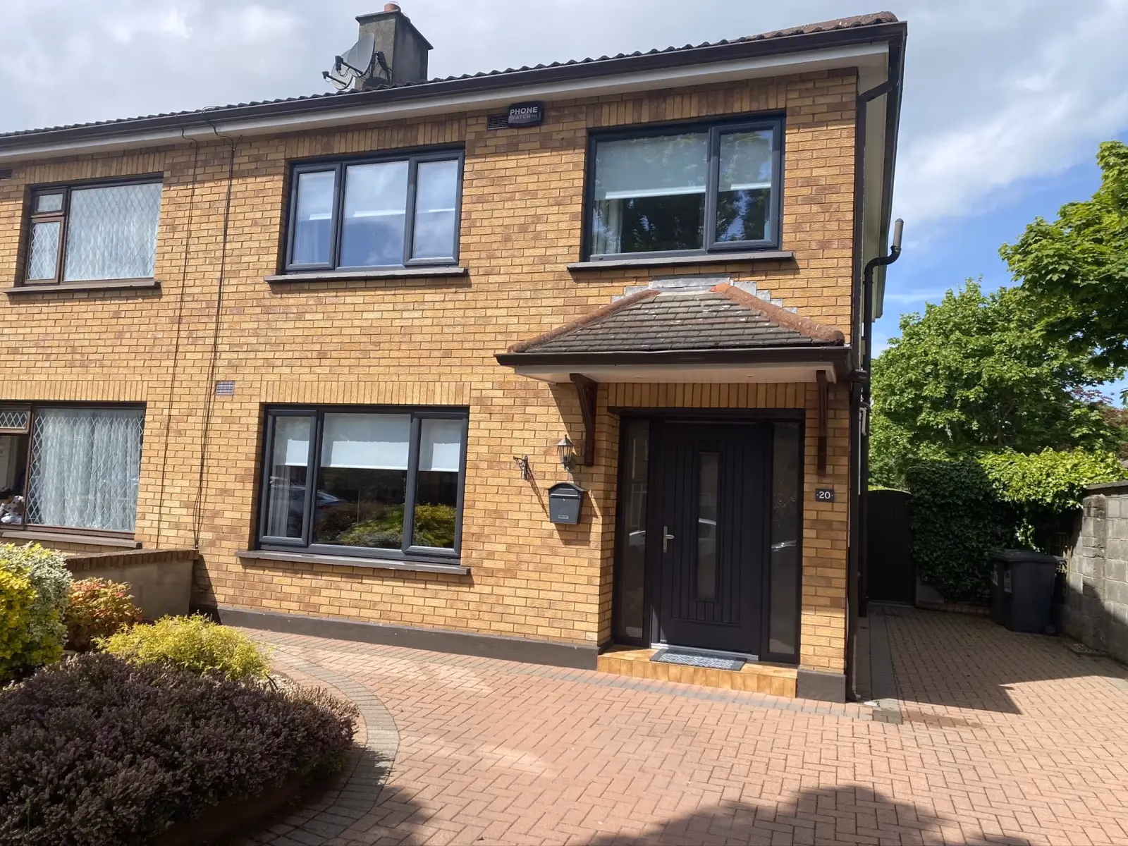 Modern brick house with black composite door
