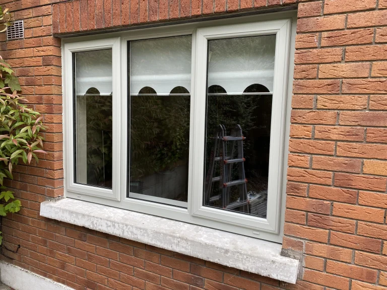 White casement windows on brick house