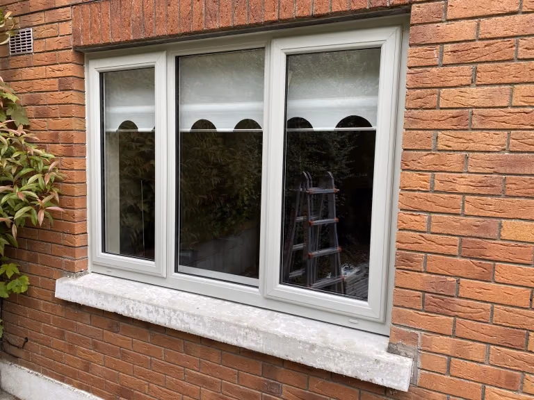 White casement windows on brick house