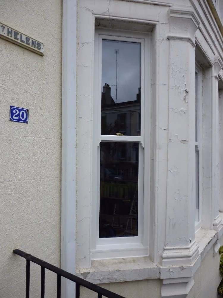 White uPVC sliding sash windows on a period Dublin terrace