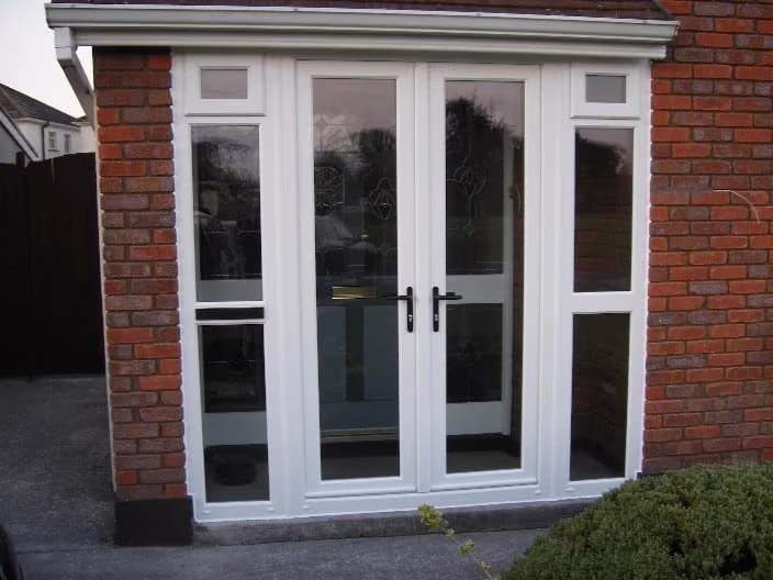 Pair of French doors opening onto a paved Dublin patio, with garden furniture and planters