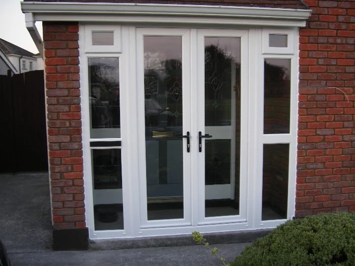 Pair of French doors opening onto a paved Dublin patio, with garden furniture and planters